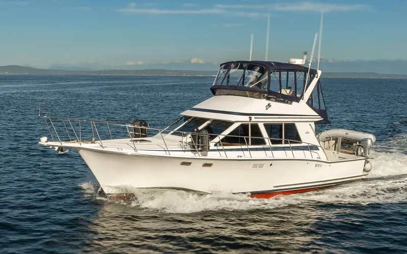Slide: The Image of 1993 Tollycraft 40 Sport Sedan cruising on open water under clear skies. - 0