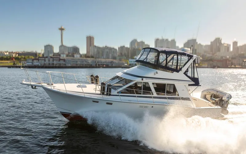 Slide: The Image of 1993 Tollycraft 40 Sport Sedan cruising with city skyline in the background. - 1