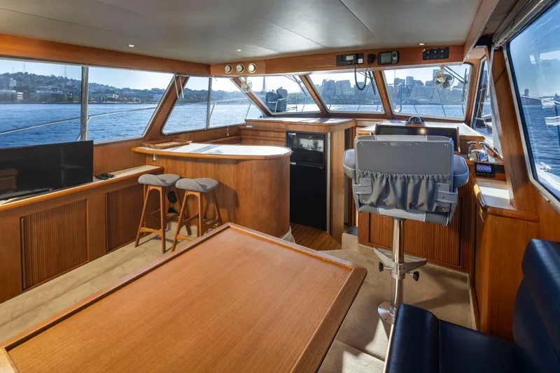 Slide: The Image of Interior of 1993 Tollycraft 40 Sport Sedan yacht with panoramic windows and elegant wood finish. - 12