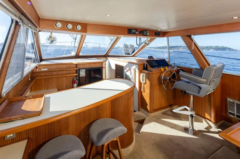 Slide: The Image of Interior of 1993 Tollycraft 40 Sport Sedan with helm, seating, and panoramic windows. - 13