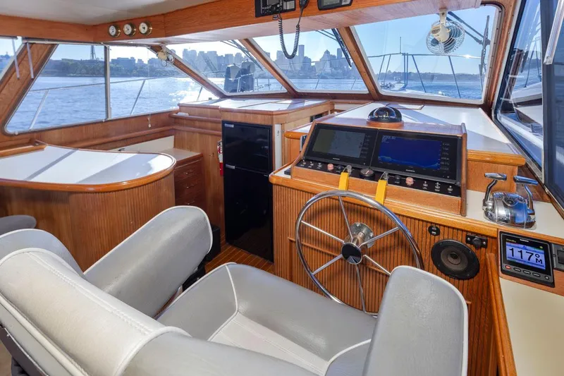 Slide: The Image of 1993 Tollycraft 40 Sport Sedan helm with modern navigation equipment and panoramic windows. - 14