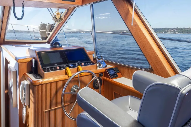 Slide: The Image of 1993 Tollycraft 40 Sport Sedan helm with wooden dashboard and ocean view. - 15
