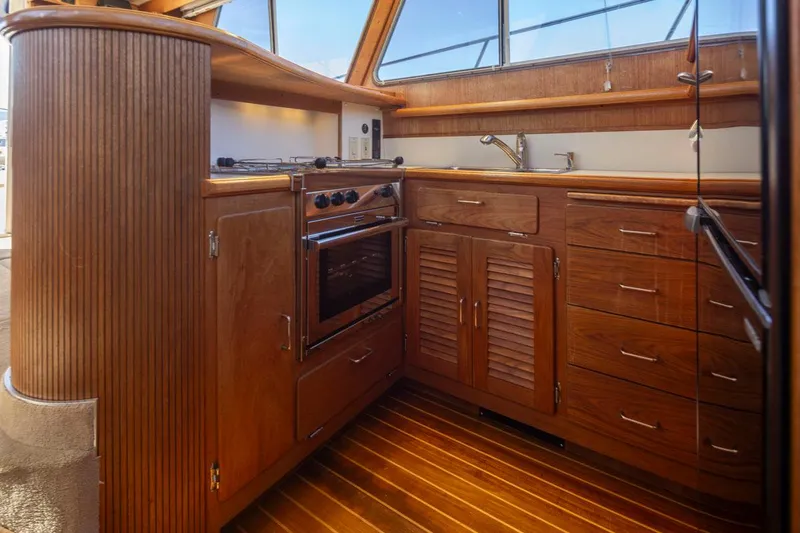 Slide: The Image of 1993 Tollycraft 40 Sport Sedan yacht kitchen with wooden cabinetry and modern appliances. - 19