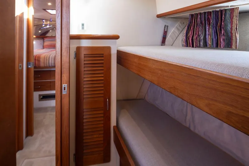 Slide: The Image of Interior of 1993 Tollycraft 40 Sport Sedan with wooden bunk beds and cozy cabin. - 24
