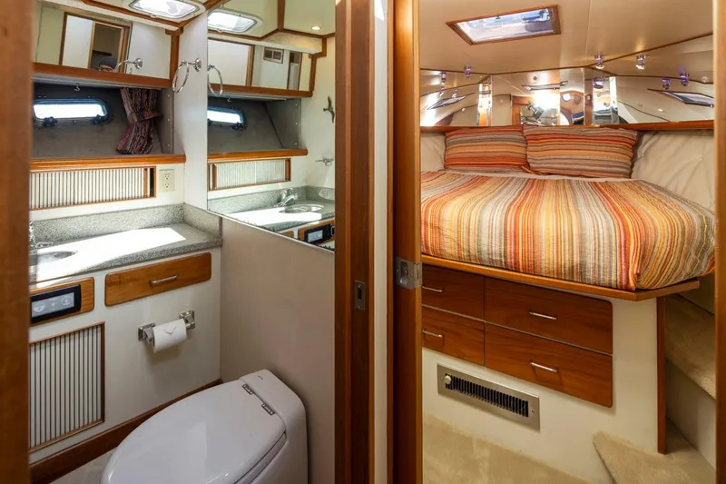 Slide: The Image of 1993 Tollycraft 40 Sport Sedan interior with bathroom and cozy bedroom. - 25