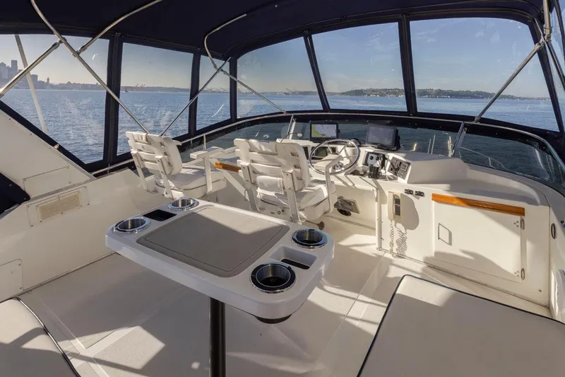 Slide: The Image of 1993 Tollycraft 40 Sport Sedan yacht interior with helm, seating, and ocean view. - 27