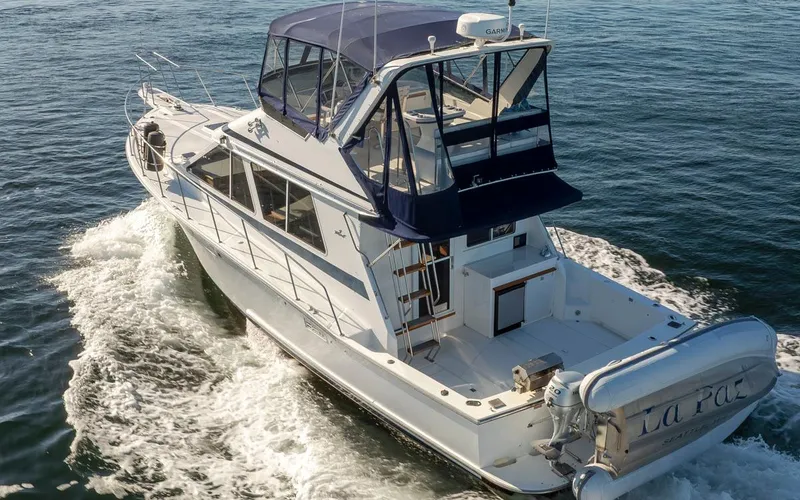 Slide: The Image of 1993 Tollycraft 40 Sport Sedan cruising on open water, rear view. - 3