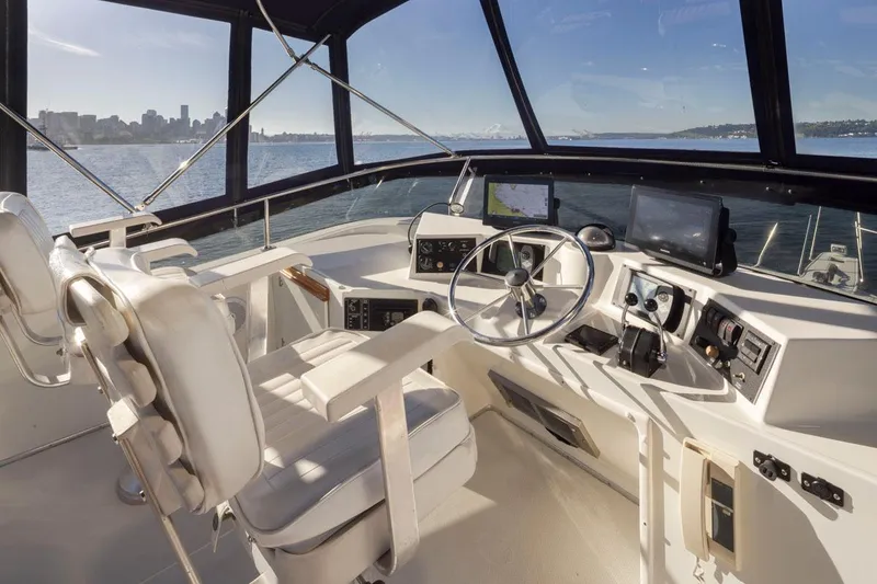 Slide: The Image of 1993 Tollycraft 40 Sport Sedan helm with city skyline view, featuring modern navigation equipment. - 30