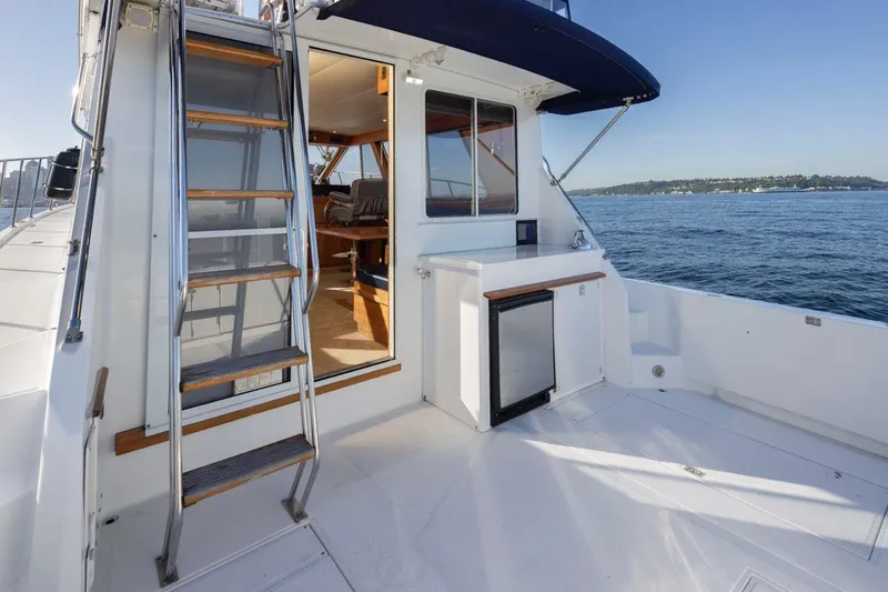 Slide: The Image of 1993 Tollycraft 40 Sport Sedan yacht deck with ladder and ocean view. - 33