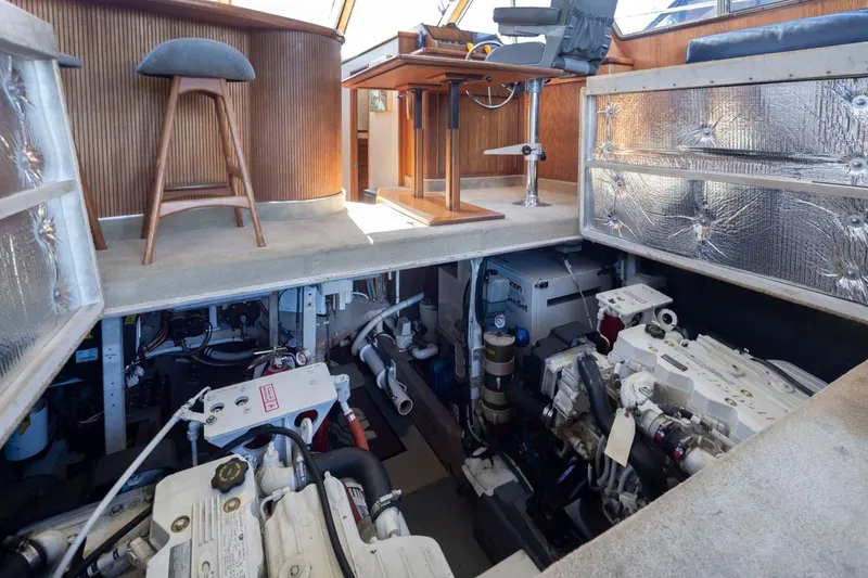 Slide: The Image of Engine room of 1993 Tollycraft 40 Sport Sedan, showcasing dual engines and interior seating. - 38