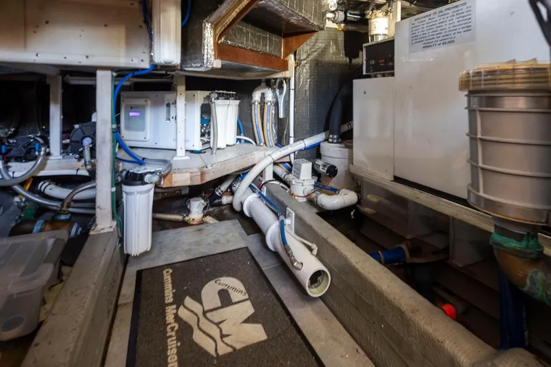 Slide: The Image of Engine room of 1993 Tollycraft 40 Sport Sedan with visible machinery and piping. - 39