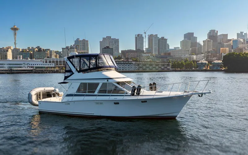 Slide: The Image of 1993 Tollycraft 40 Sport Sedan yacht on water with city skyline in background. - 4