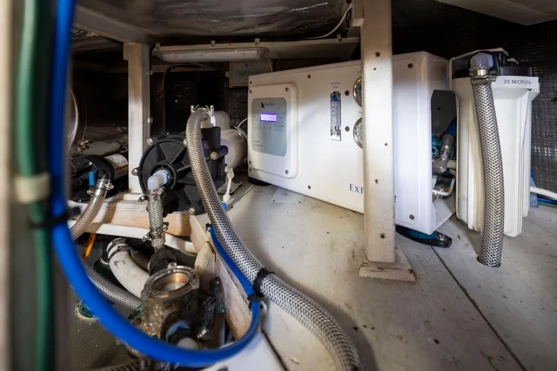 Slide: The Image of Engine room of 1993 Tollycraft 40 Sport Sedan with mechanical equipment and piping. - 40