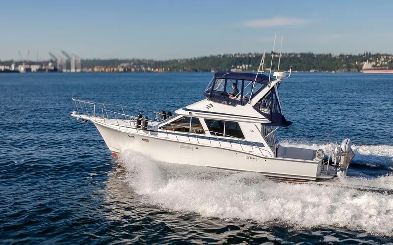 Slide: The Image of 1993 Tollycraft 40 Sport Sedan cruising on open water under clear skies. - 41