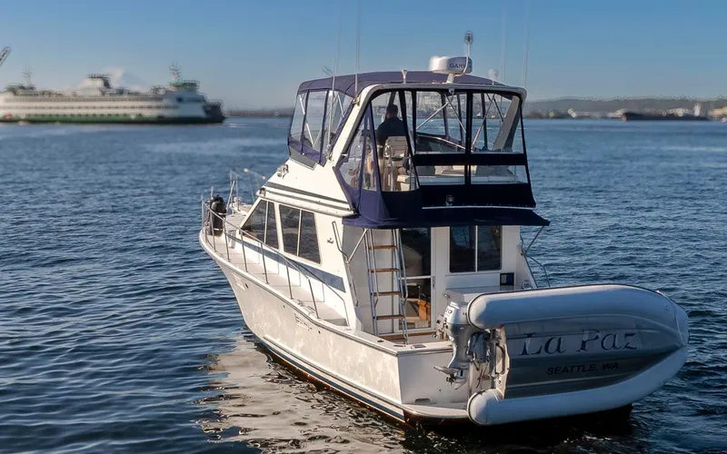 Slide: The Image of 1993 Tollycraft 40 Sport Sedan yacht on calm water with ferry in background. - 5
