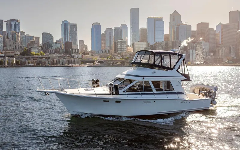 Slide: The Image of 1993 Tollycraft 40 Sport Sedan cruising with city skyline in background. - 7