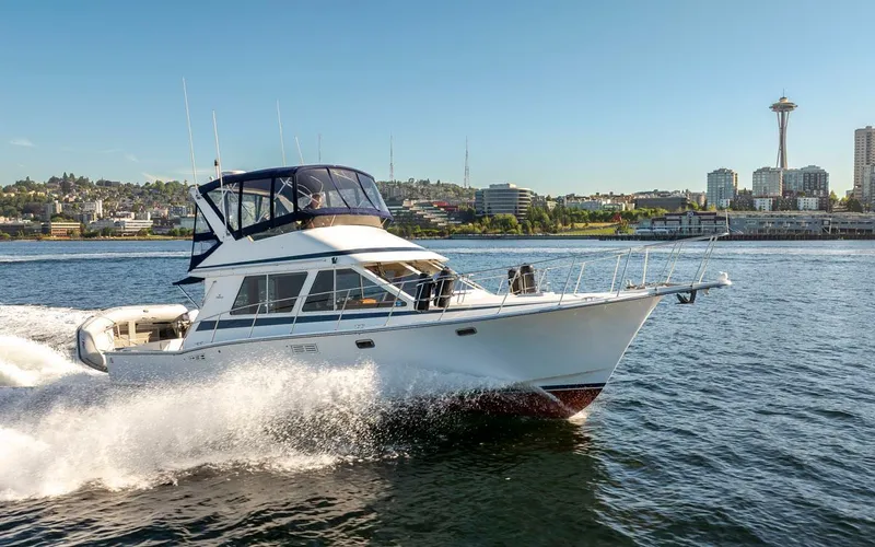 Slide: The Image of 1993 Tollycraft 40 Sport Sedan cruising on water near city skyline. - 8