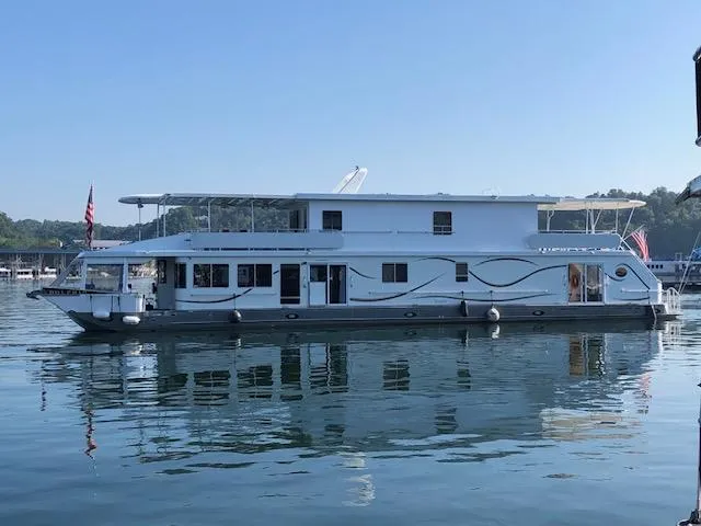 The Image of 2001 Stardust Cruisers 18 x 103 houseboat on calm water, side view. - 1