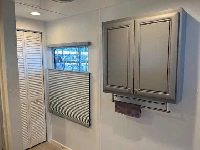 Slide: The Image of Interior of 2001 Stardust Cruisers houseboat with cabinet, window, and closet. - 16
