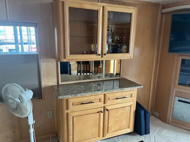 Slide: The Image of Wooden cabinet with glass doors and granite countertop in a 2001 Stardust Cruisers houseboat. - 20