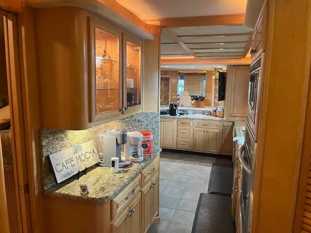 Slide: The Image of Luxurious kitchen interior of a 2001 Stardust Cruisers houseboat with modern amenities. - 24