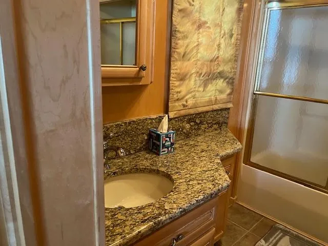 Slide: The Image of Luxurious bathroom in 2001 Stardust Cruisers houseboat with granite countertop and glass shower. - 27