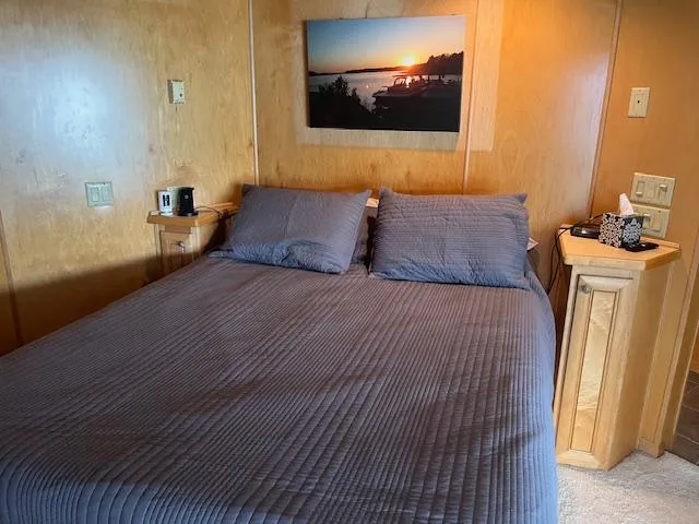 Slide: The Image of Cozy bedroom in 2001 Stardust Cruisers houseboat with sunset artwork and wooden decor. - 30