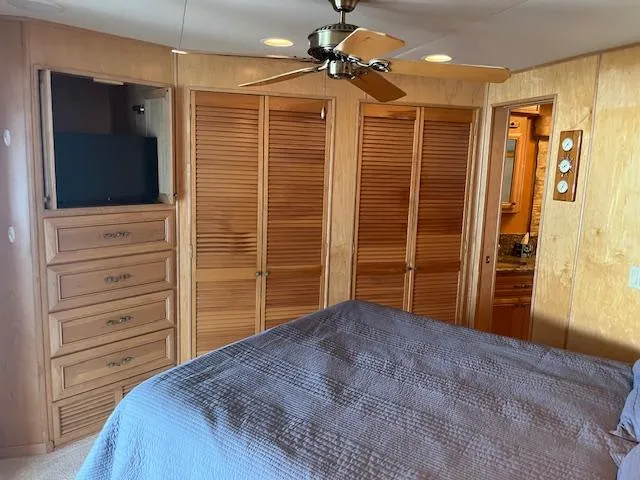 Slide: The Image of Bedroom interior of 2001 Stardust Cruisers houseboat with wooden closets and ceiling fan. - 31