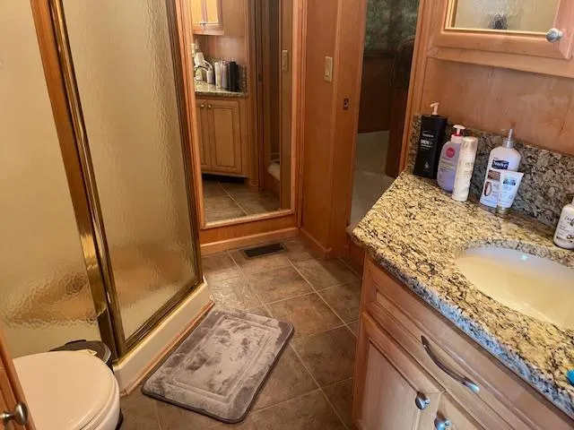 Slide: The Image of Luxurious bathroom in 2001 Stardust Cruisers houseboat with granite countertop and shower. - 34