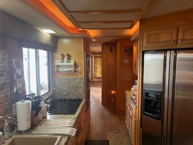 Slide: The Image of Luxurious kitchen interior of a 2001 Stardust Cruisers 18 x 103 houseboat with modern amenities. - 39