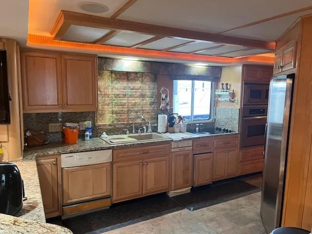 Slide: The Image of Spacious kitchen in 2001 Stardust Cruisers houseboat with wooden cabinets and modern appliances. - 41