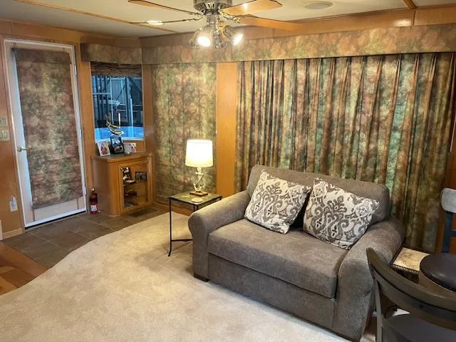 Slide: The Image of Cozy living area in 2001 Stardust Cruisers houseboat with sofa, lamp, and patterned curtains. - 46