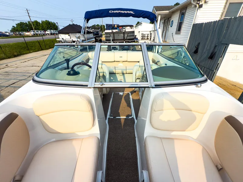 Slide: The Image of 2007 Chaparral 190 SSi boat interior with beige seating and blue canopy. - 23