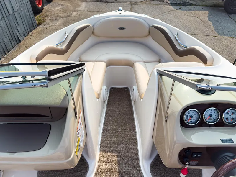 Slide: The Image of 2007 Chaparral 190 SSi boat interior with beige seating and dashboard gauges. - 24