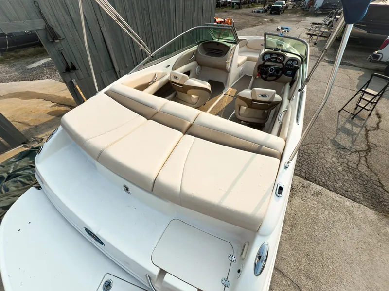 Slide: The Image of 2007 Chaparral 190 SSi boat with beige seating, docked outdoors. - 6