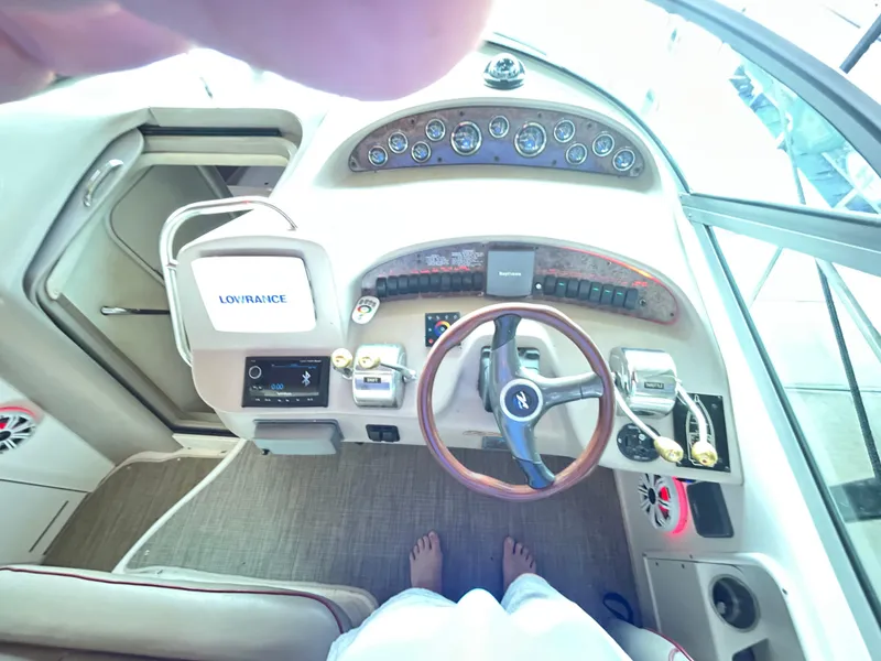Slide: The Image of 2001 Sea Ray 340 Sundancer helm with steering wheel, gauges, and navigation equipment. - 12