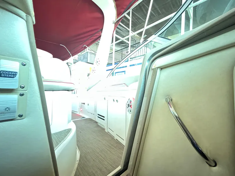 Slide: The Image of Interior view of 2001 Sea Ray 340 Sundancer boat with red canopy and cockpit details. - 16