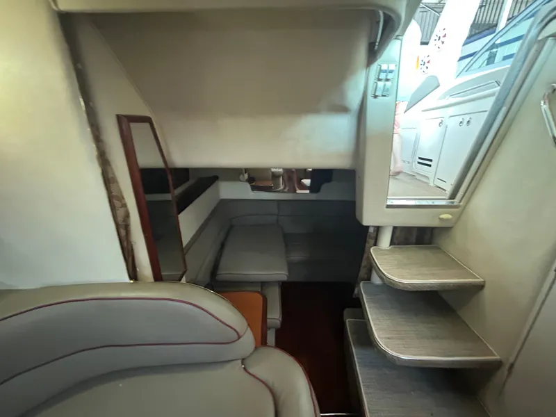 Slide: The Image of Interior of 2001 Sea Ray 340 Sundancer yacht, featuring seating and stairs. - 17