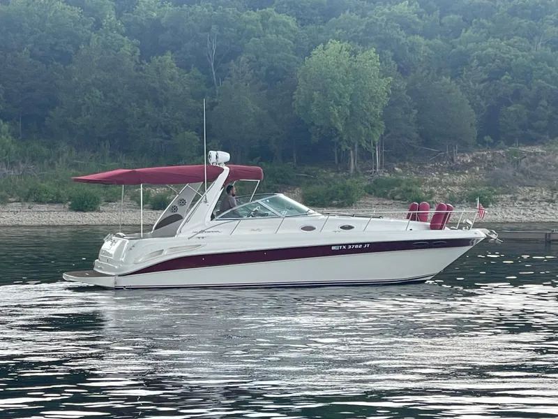 Slide: The Image of 2001 Sea Ray 340 Sundancer boat with red canopy on a calm lake. - 5