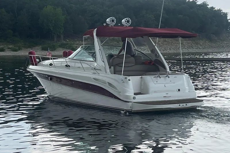 Slide: The Image of 2001 Sea Ray 340 Sundancer boat with maroon canopy on a calm lake. - 6