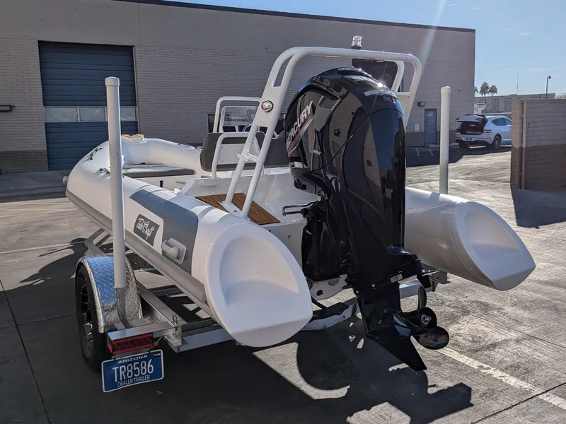 Slide: The Image of 2025 Tide Craft Kodiak 16 boat cruising in a scenic harbor with hillside homes. - 9