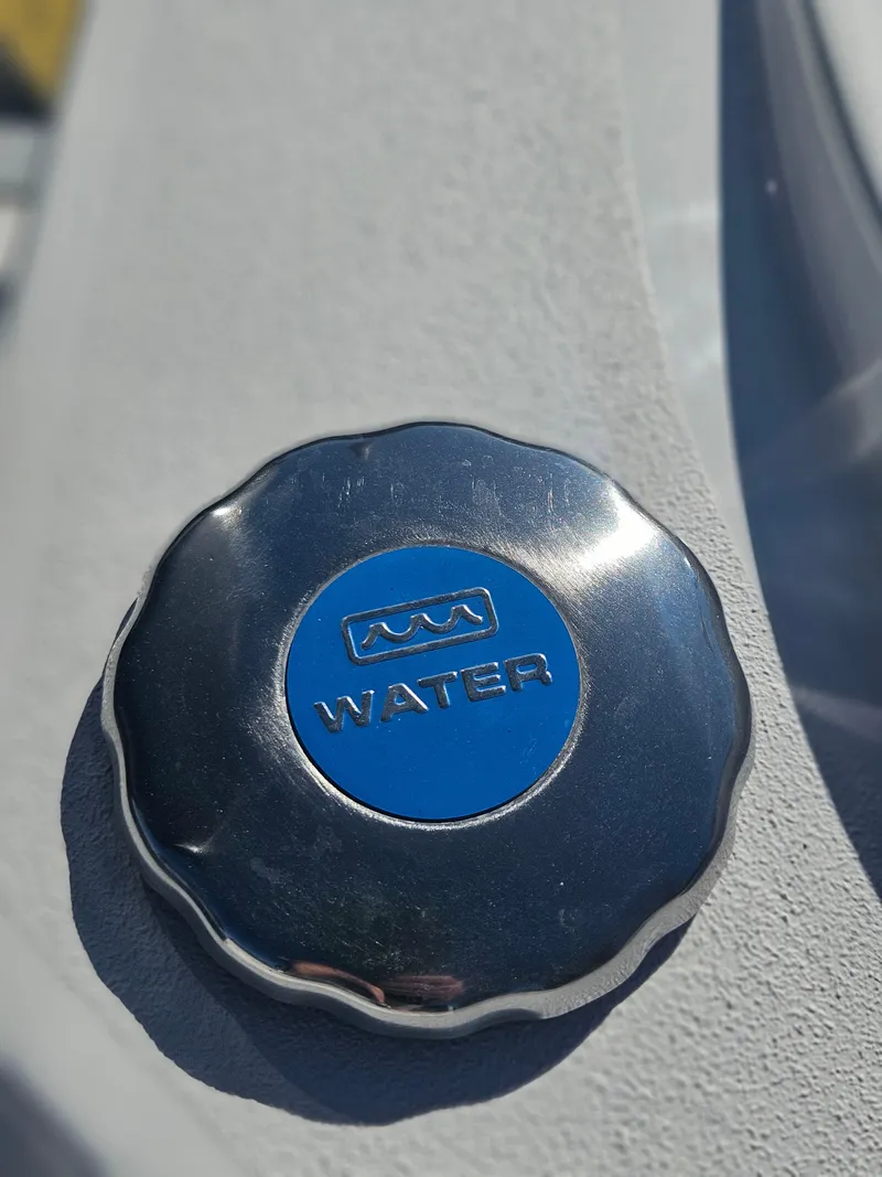 Slide: The Image of Water cap on 2026 Sea Hunt BX 22 BR boat, close-up view. - 10