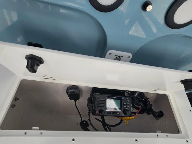 Slide: The Image of 2026 Sea Hunt BX 22 BR boat console with radio equipment and storage compartment. - 16