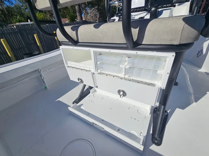 Slide: The Image of 2026 Sea Hunt BX 22 BR boat storage compartments with seating, showcasing organized tackle boxes. - 18