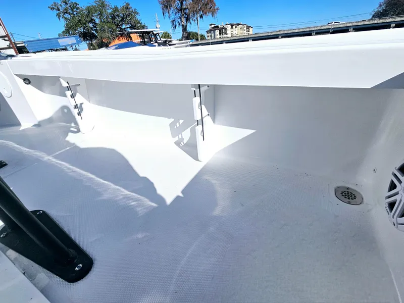 Slide: The Image of 2026 Sea Hunt BX 22 BR boat interior, showcasing clean white deck and storage compartments. - 19