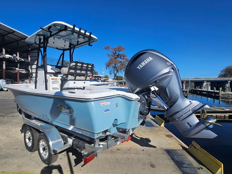 Slide: The Image of 2026 Sea Hunt BX 22 BR boat with Yamaha engine on trailer, dockside. - 2