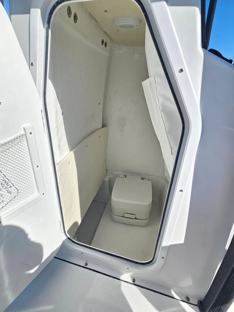 Slide: The Image of 2026 Sea Hunt BX 22 BR boat interior with compact marine toilet. - 21