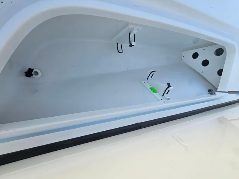 Slide: The Image of Storage compartment of 2026 Sea Hunt BX 22 BR boat, featuring secure latches and spacious interior. - 23