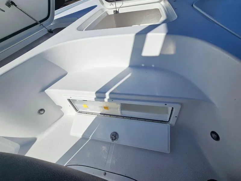 Slide: The Image of 2026 Sea Hunt BX 22 BR boat interior with storage compartments and seating area. - 27
