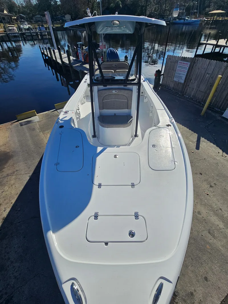 Slide: The Image of 2026 Sea Hunt BX 22 BR boat docked by a serene waterfront. - 29